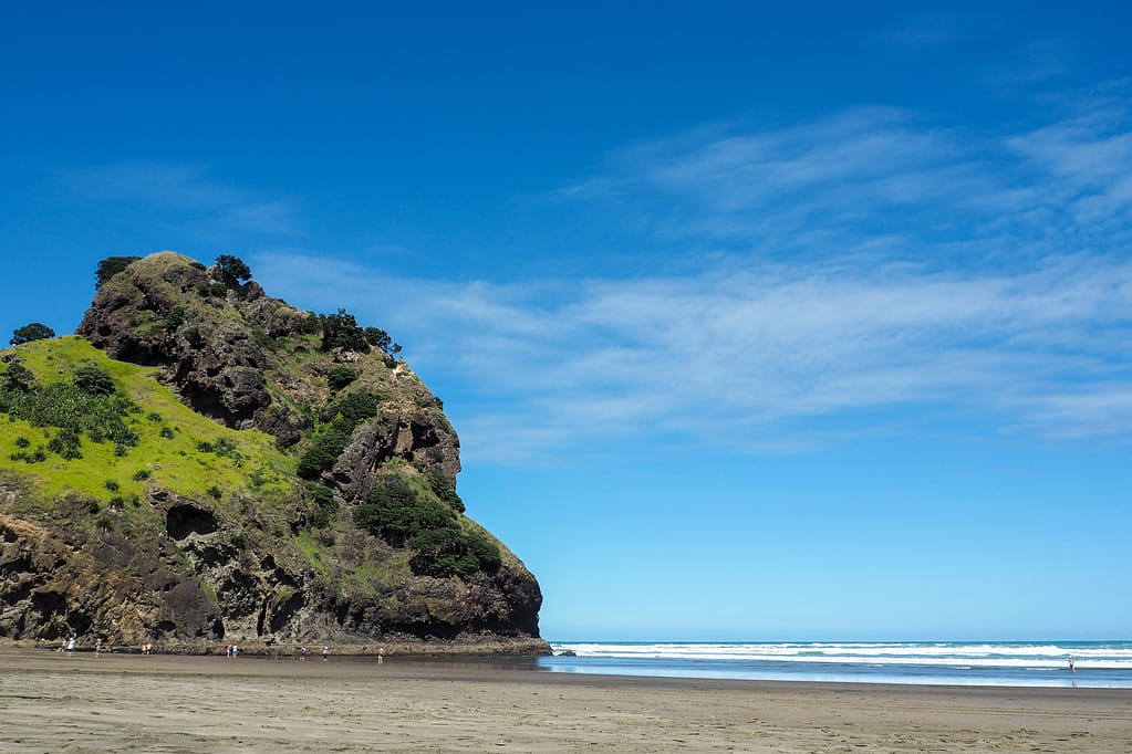 Lion Rock, a rocky hill shaped like a lions head that extends into the sea at Piha.